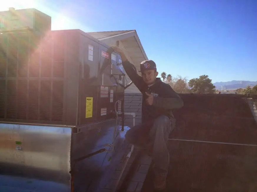 HVAC technician performing HVAC Inspection on a rooftop unit in Wylie